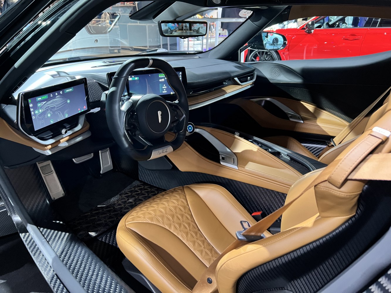 Luxury interior with leather seats, digital displays, and carbon fiber trim