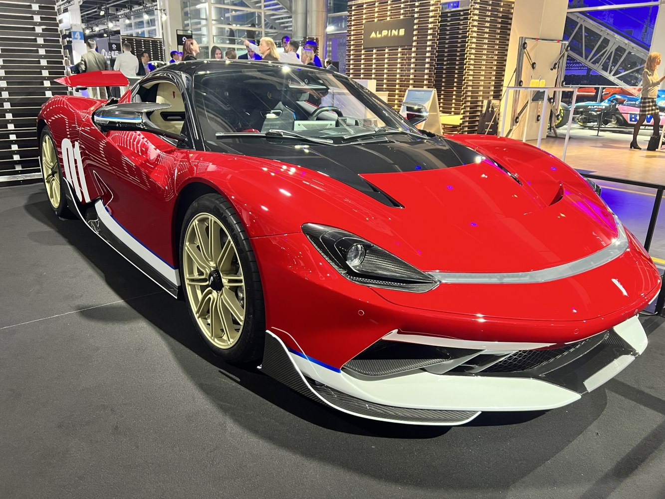 Red racing supercar with aerodynamic design and gold wheels