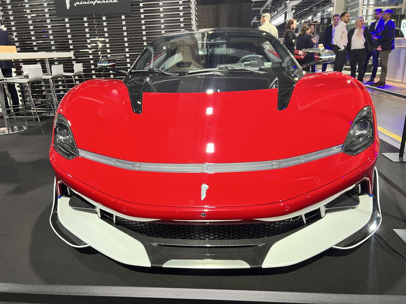 Sleek sports car front with aerodynamic hood and sharp headlights.