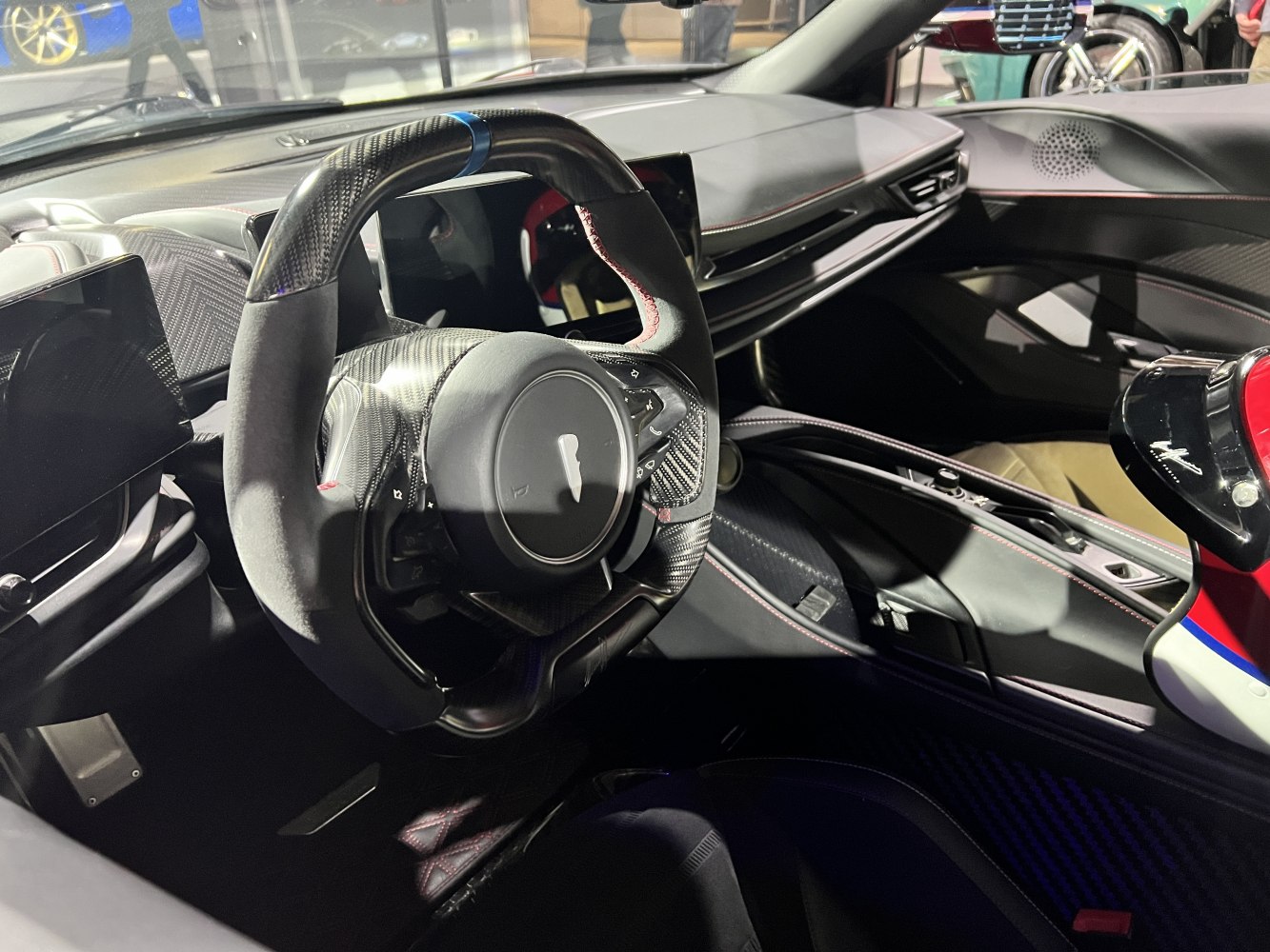 Carbon fiber sport steering wheel and digital dashboard in luxury car interior