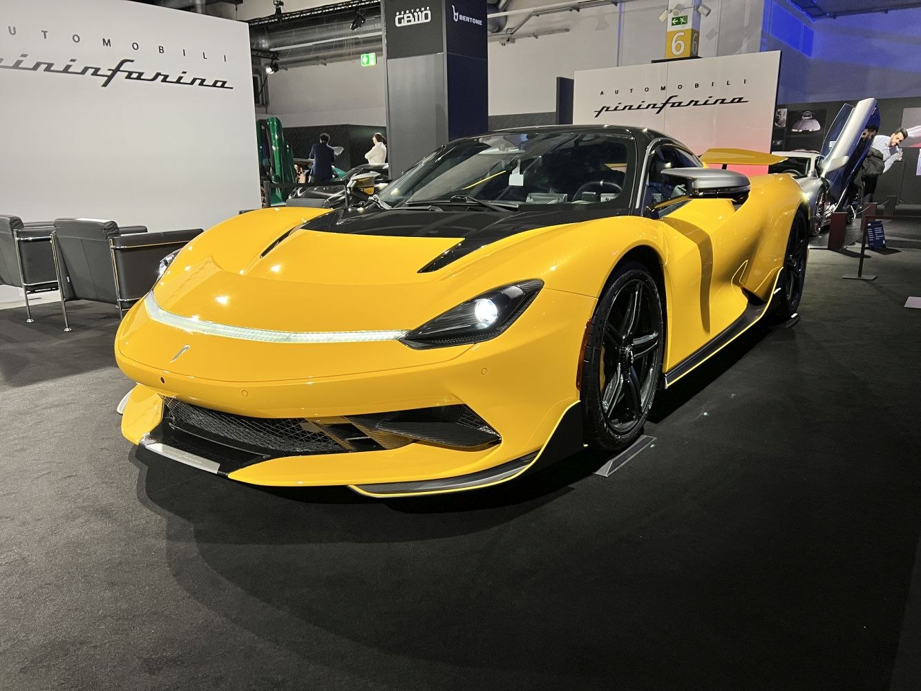 Sleek yellow hypercar with illuminated front light strip and aerodynamic body