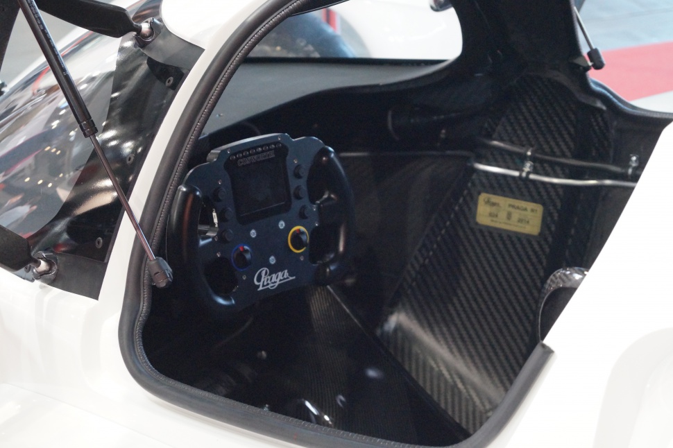 Racecar cockpit with advanced steering wheel and carbon fiber interior
