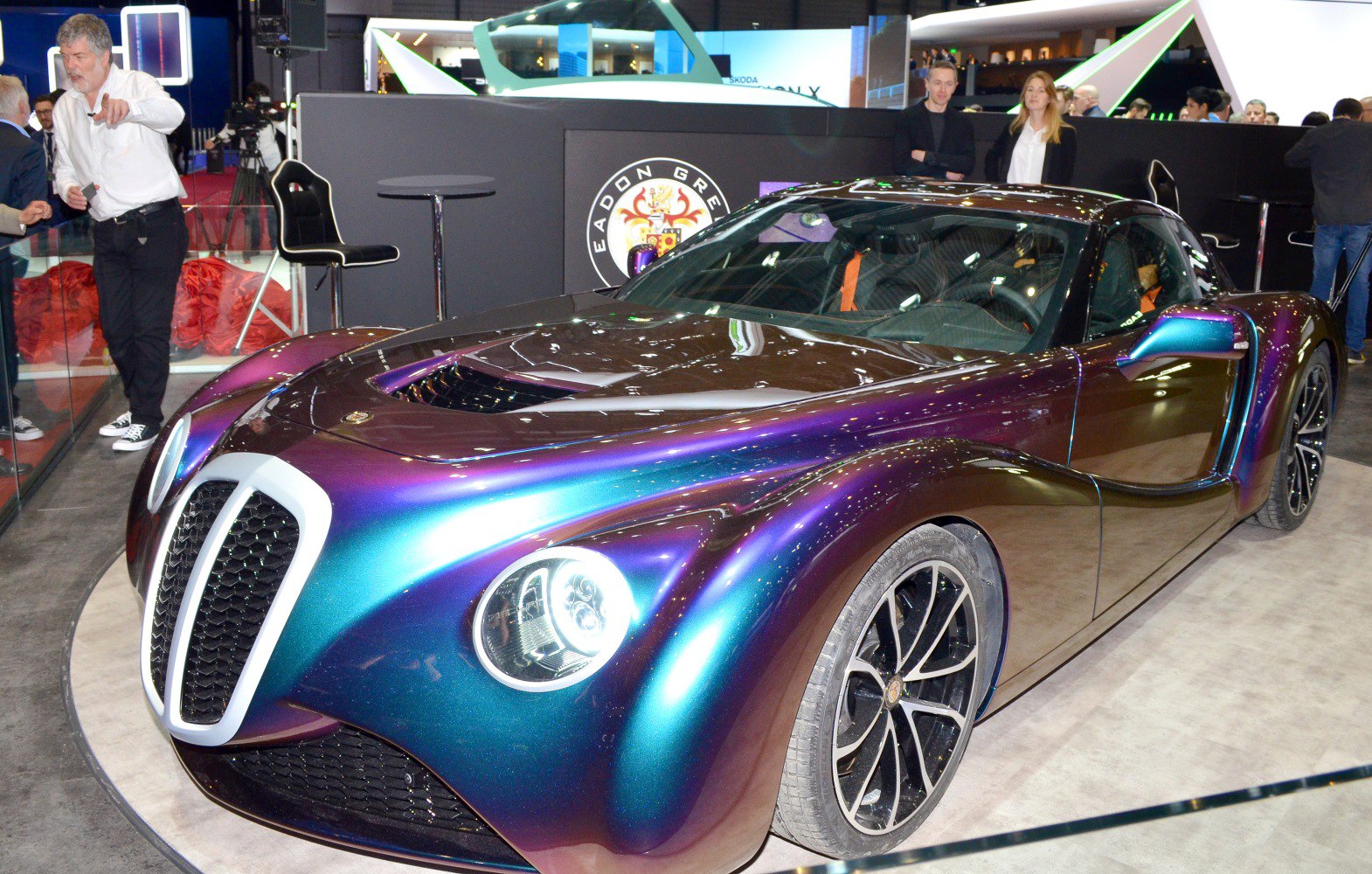 Retro-futuristic luxury coupe with iridescent paint and unique grille