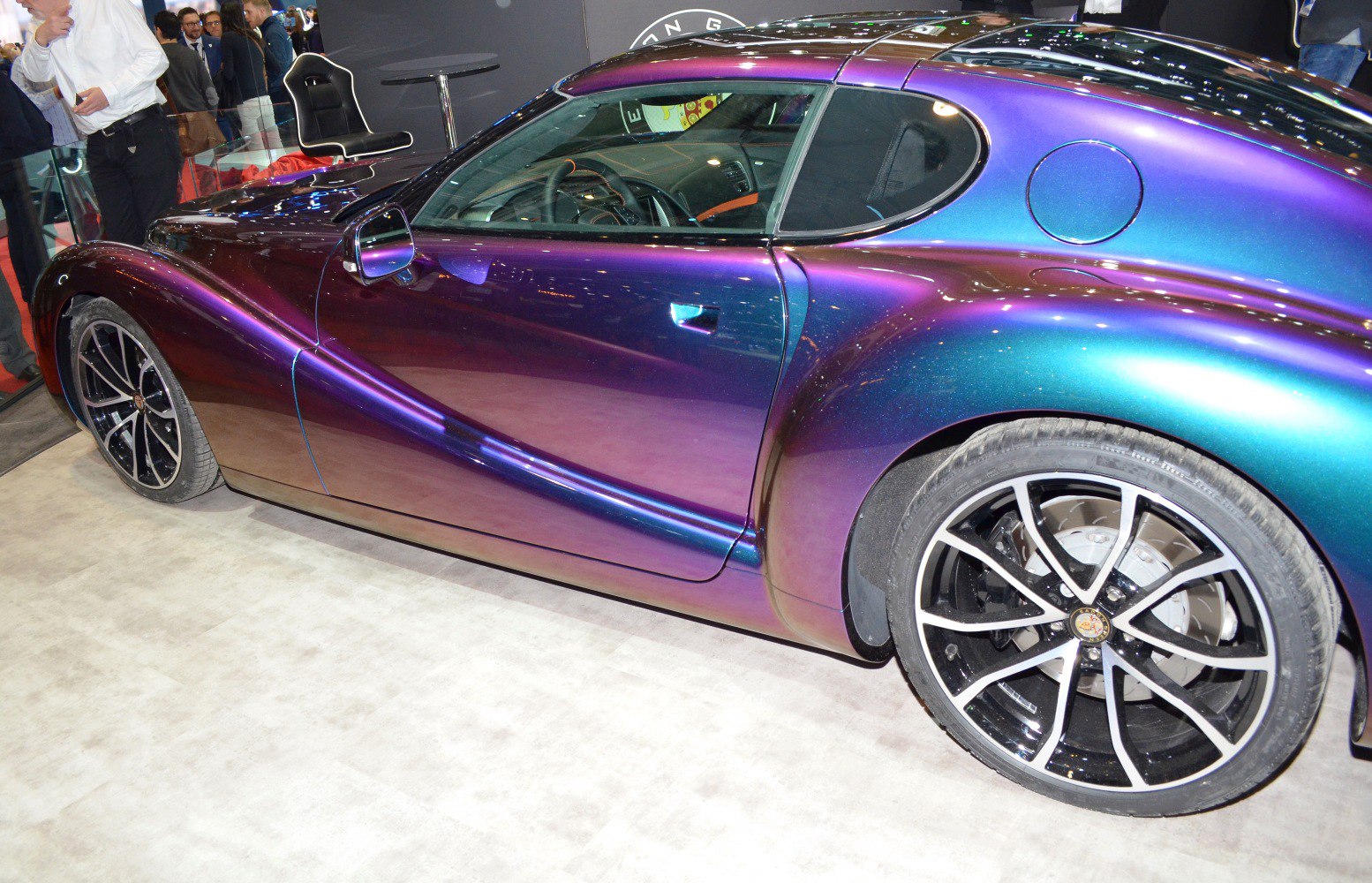 Iridescent paint with sleek multi-spoke alloy wheels on a curvy sports coupe