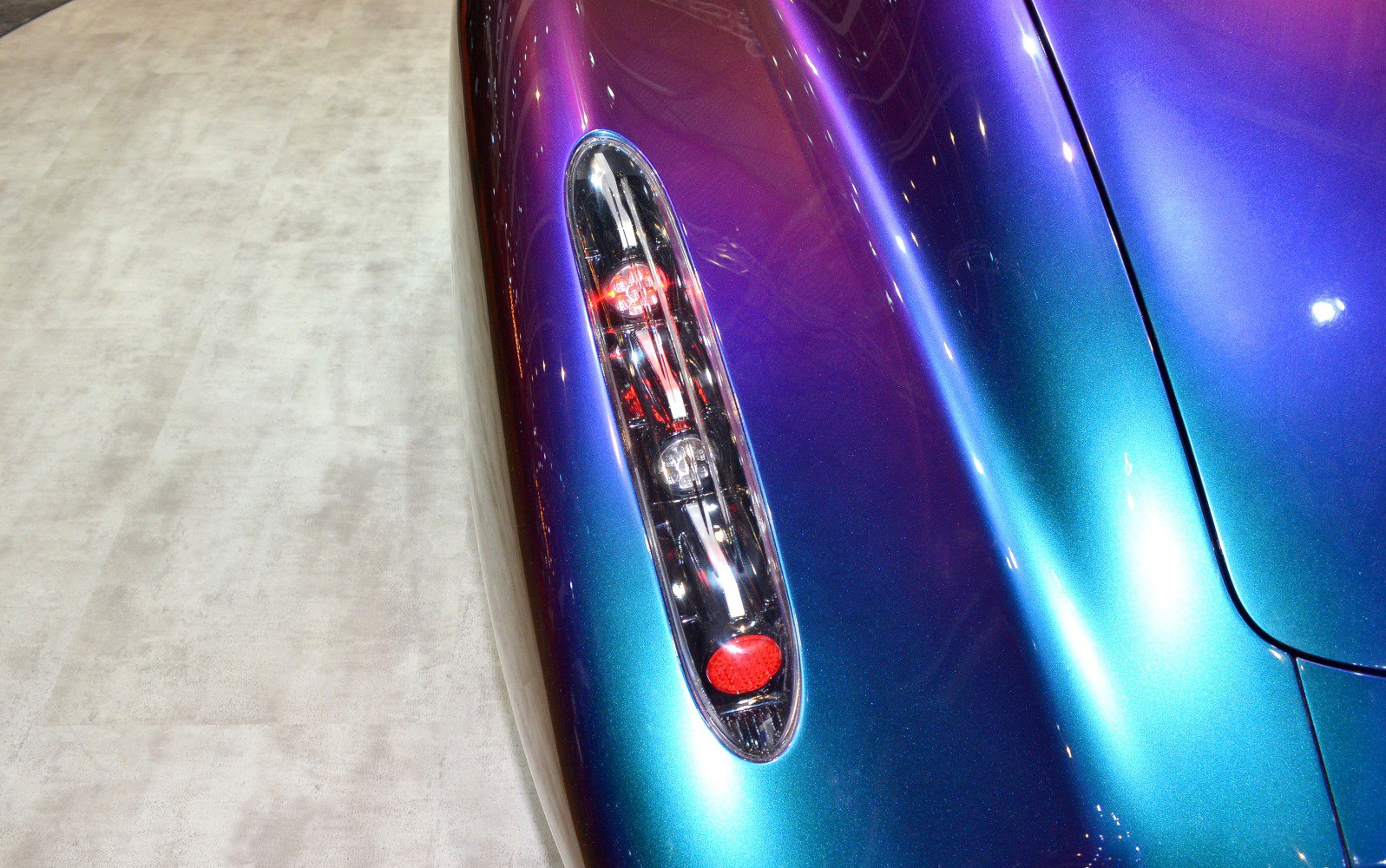 Close-up of distinctive rear light cluster and metallic paint finish