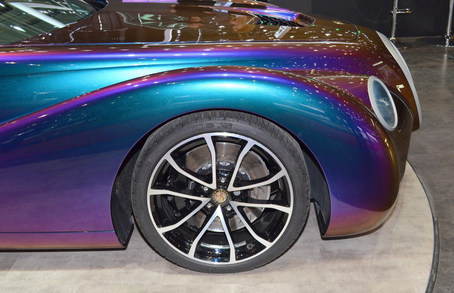 Front wheel and curved fender close-up with glossy paint