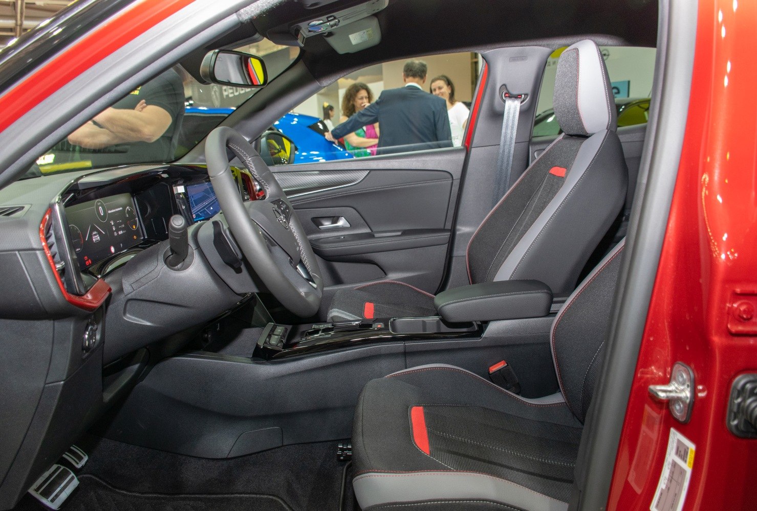Digital dashboard and sporty front seat with red accents