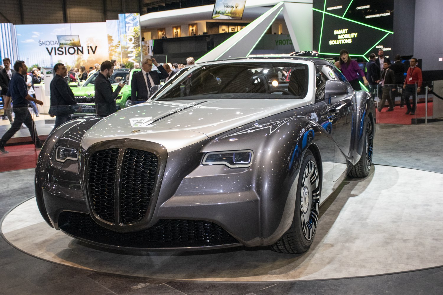 Large grille and sleek headlights on retro-modern coupe front
