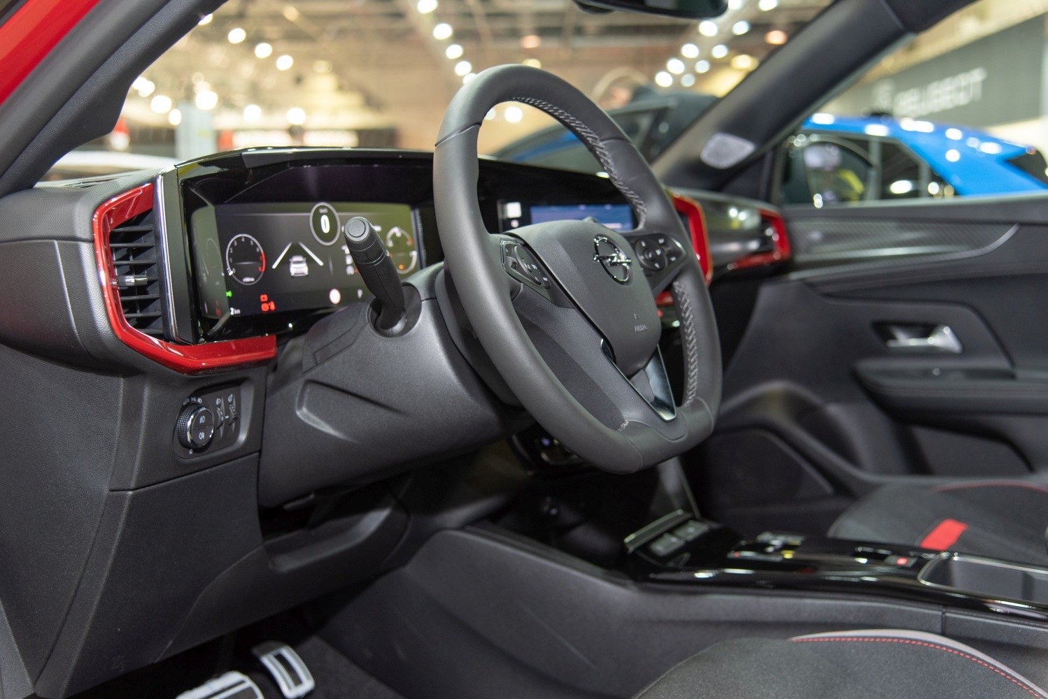 Digital dashboard and multifunction steering with red trim accents.