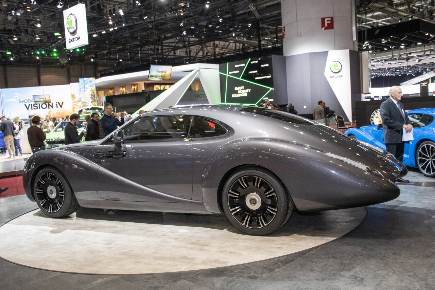 Streamlined retro-futuristic luxury coupe with sleek wheels and elegant silhouette