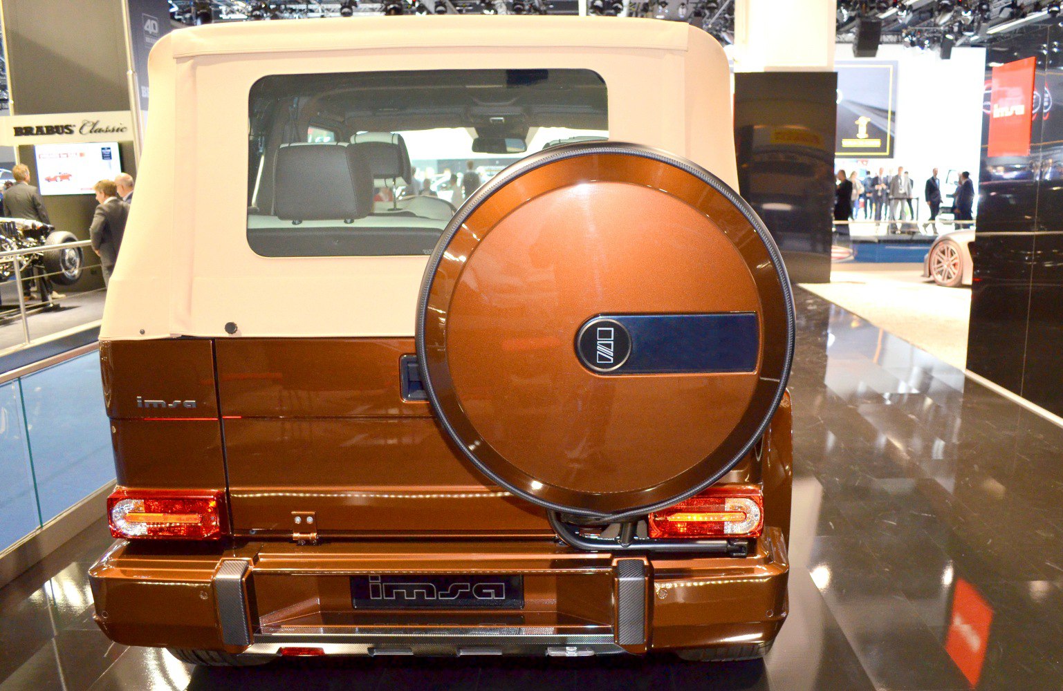 Rear view showing spare tire cover and tail light design on SUV