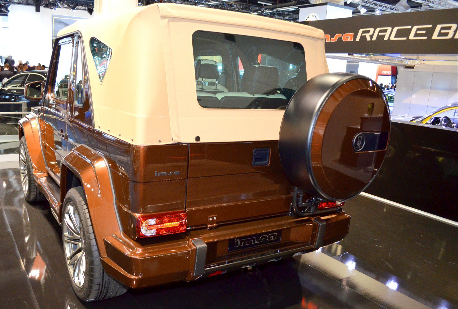 Rear view with beige soft top and round spare wheel cover