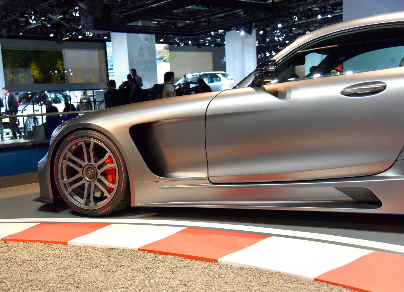 Close-up of sleek front side and wheel with red brake caliper