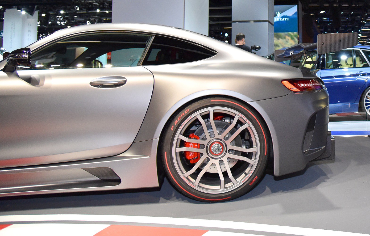 Rear wheel with red brake caliper and aerodynamic side panel