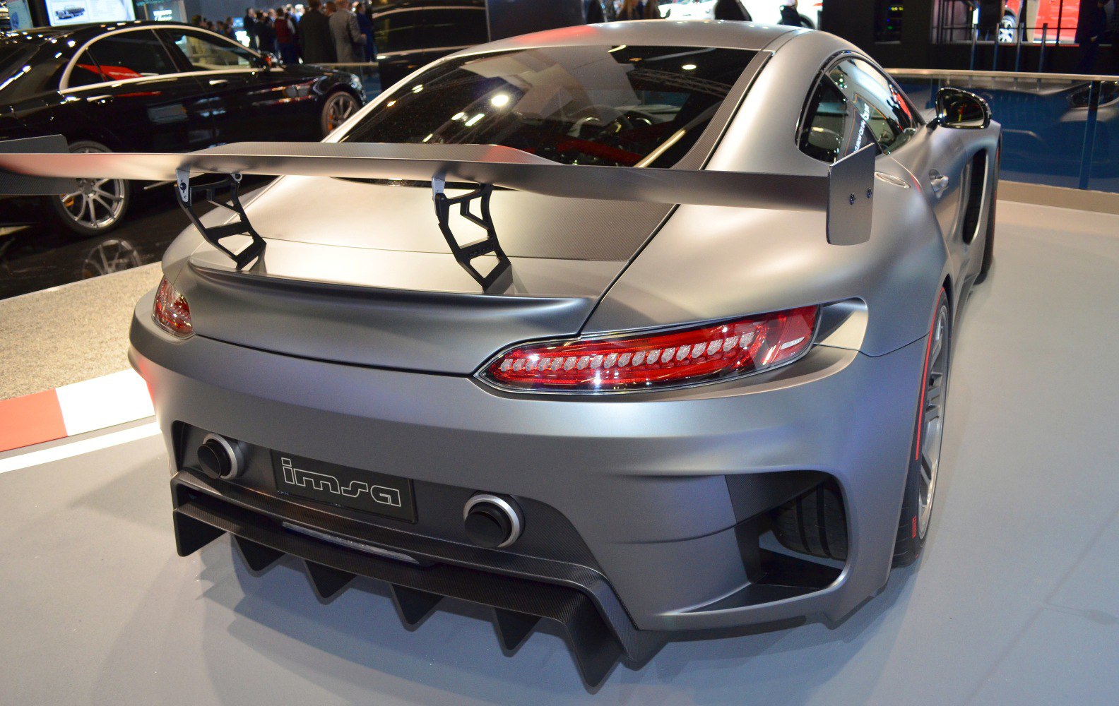 Rear of a sports vehicle with prominent spoiler and aerodynamic diffuser