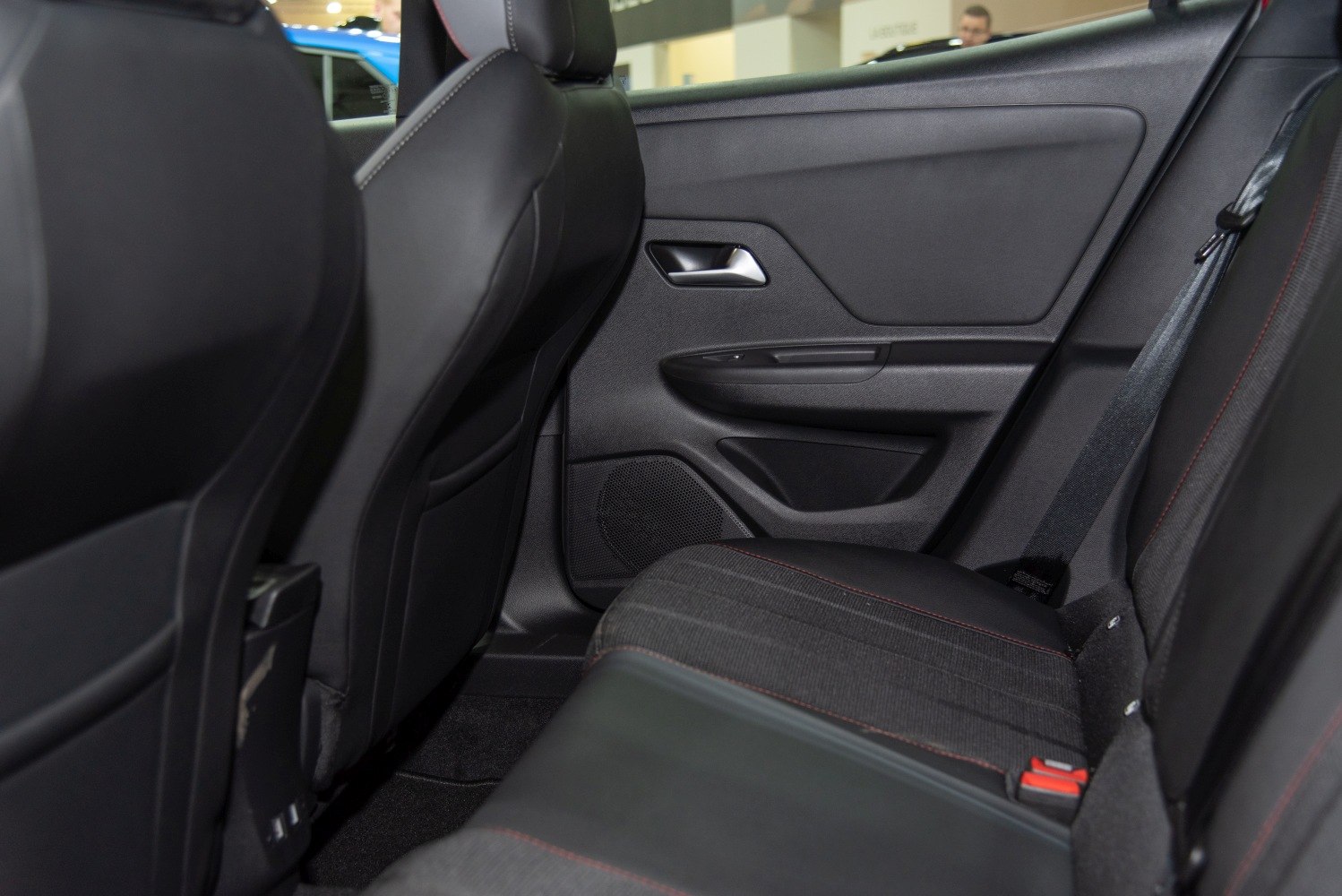 Rear seat and door panel interior with upholstery and seat belt