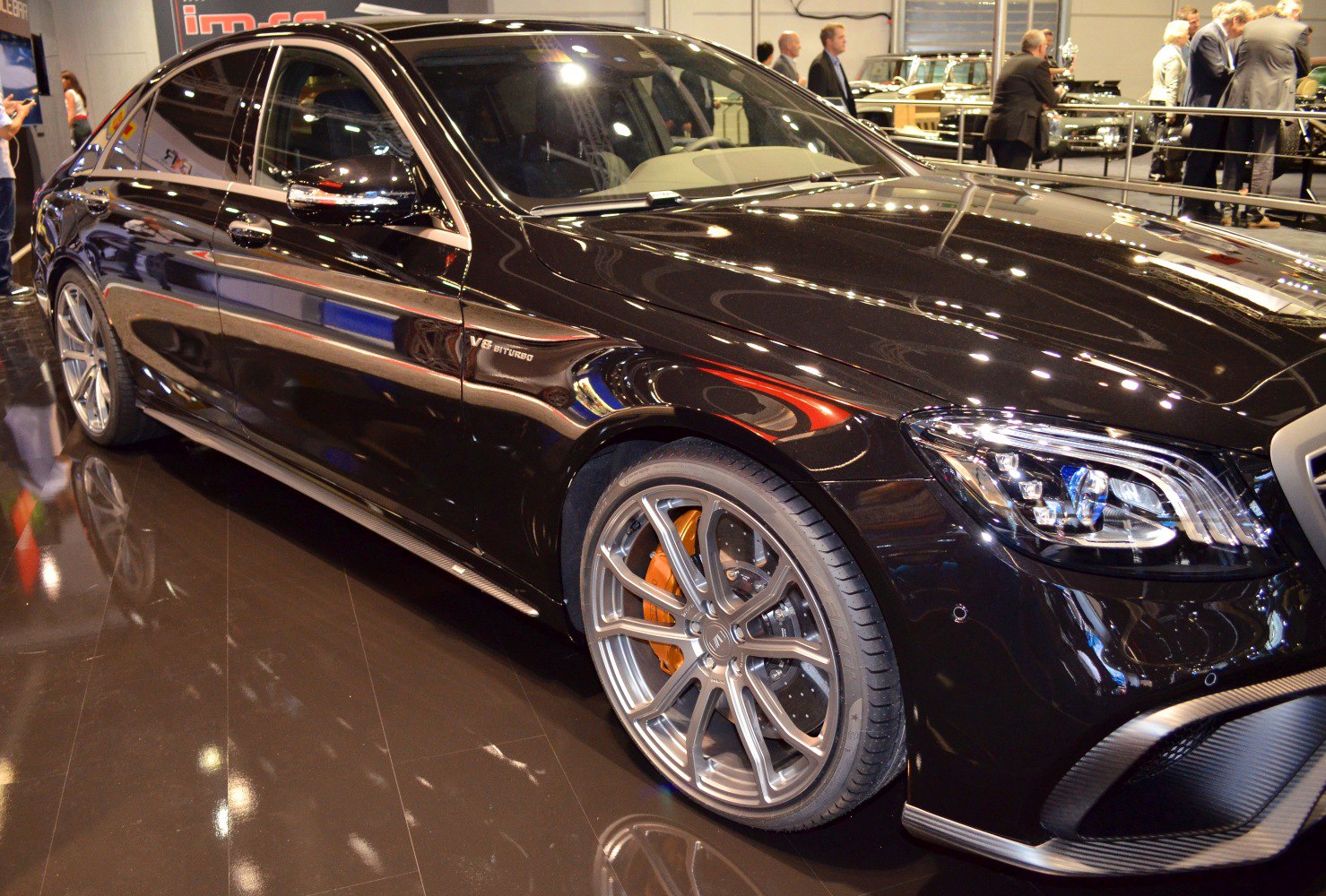 Black luxury sedan with V8 biturbo badge and sport alloy wheels
