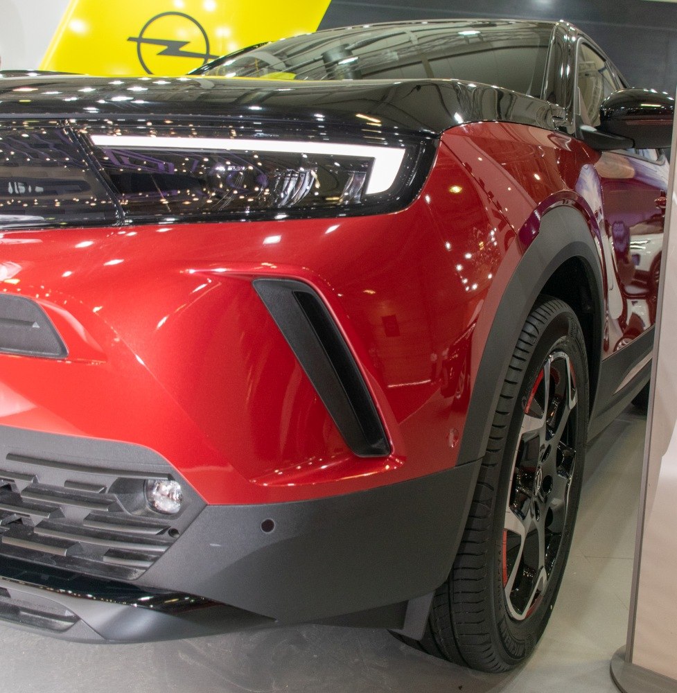 Close-up of front headlight and wheel details with red and black design elements