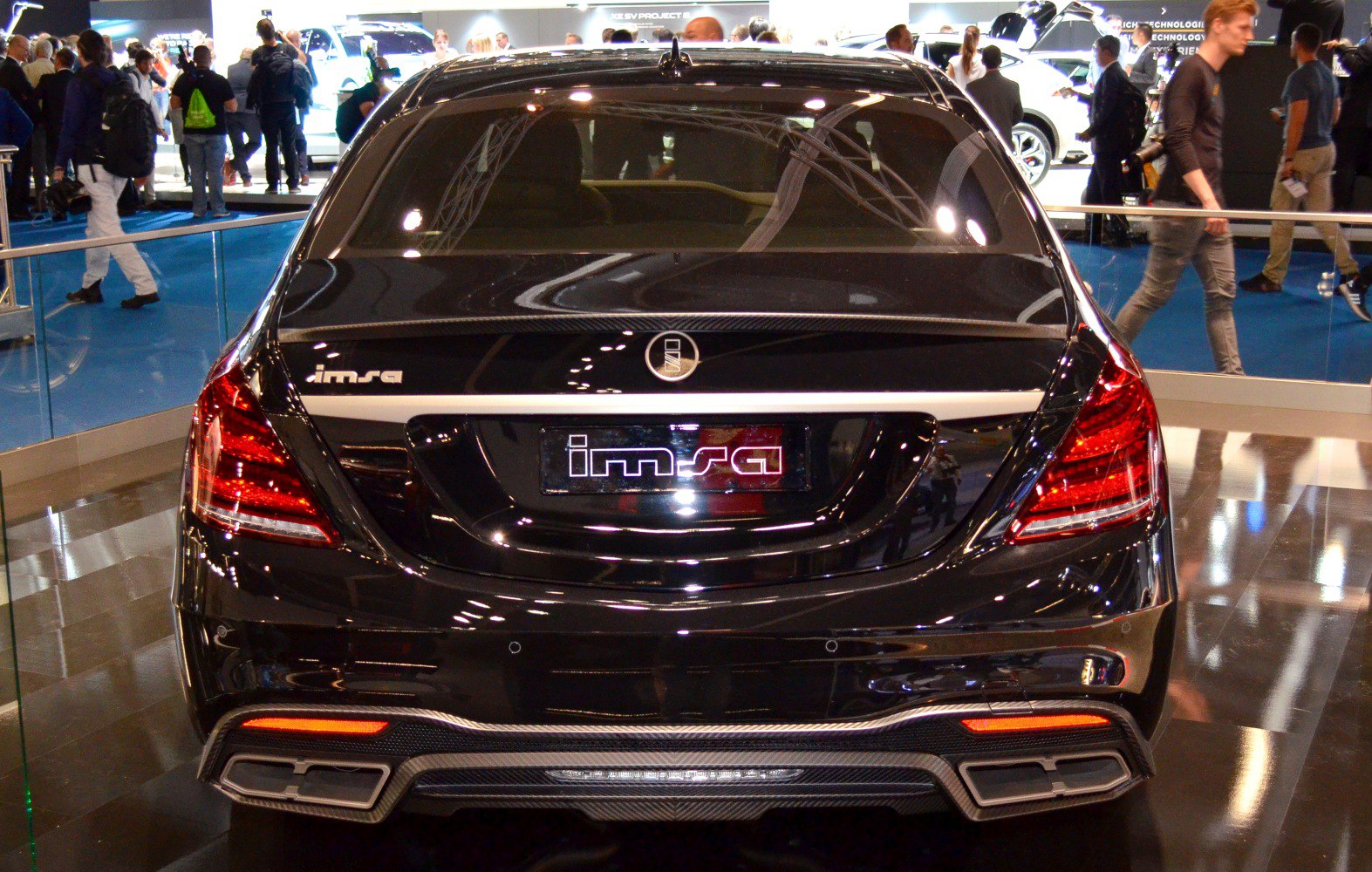 Rear view of a luxury sedan with LED tail lights and dual exhaust tips