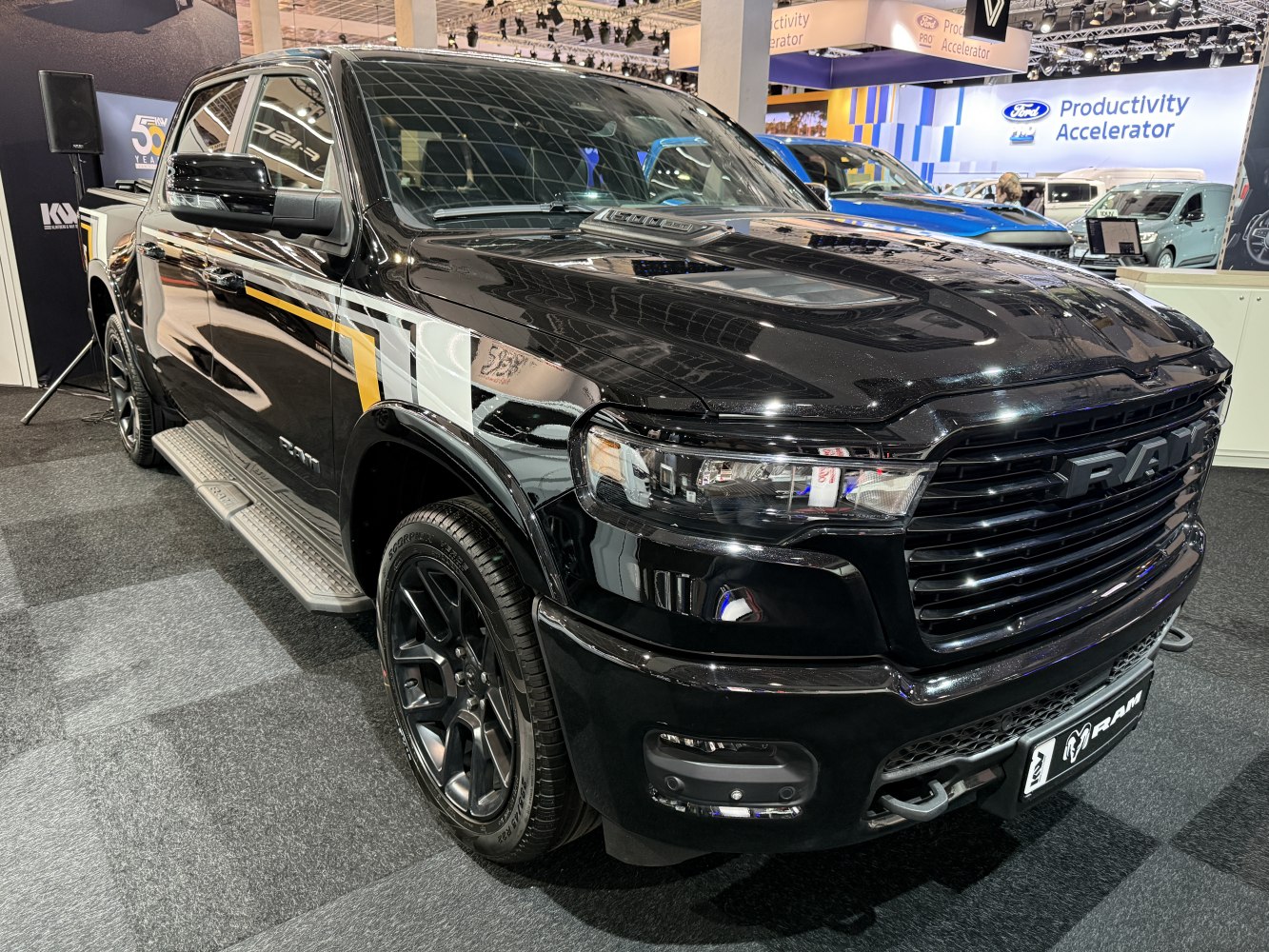 Black grille, LED headlights, side steps on pickup truck front and side.
