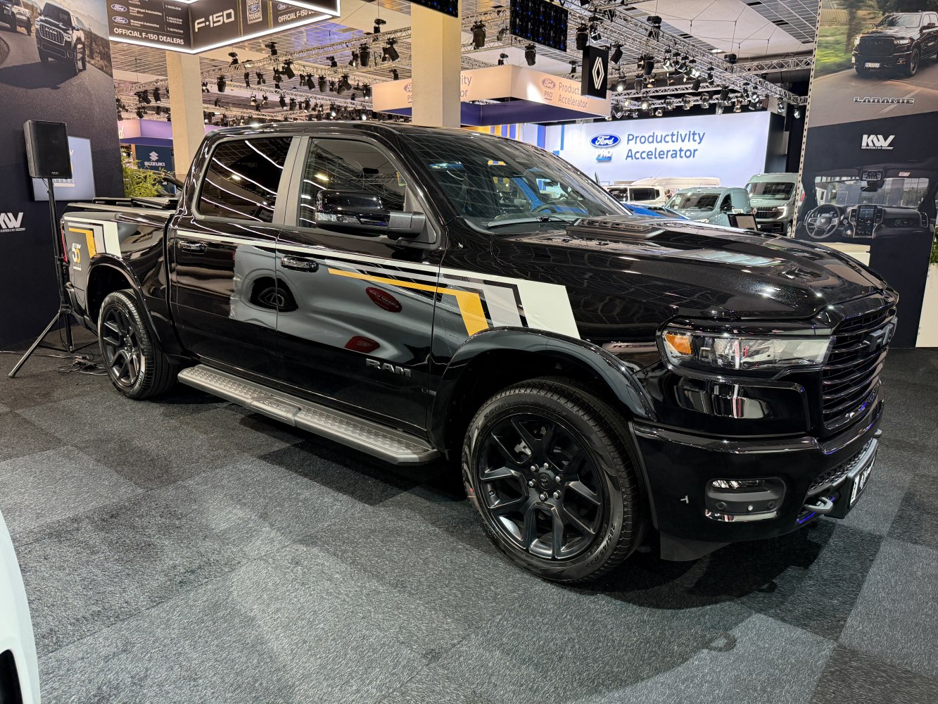 Black pickup with crew cab, black wheels, modern grille, and graphic side decals