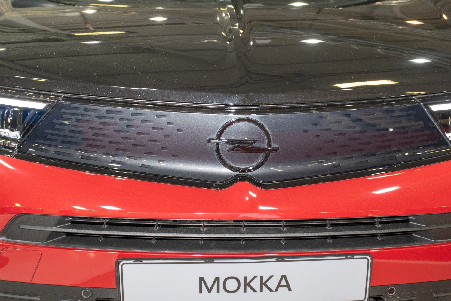 Close-up of front grille with Opel logo and red bumper