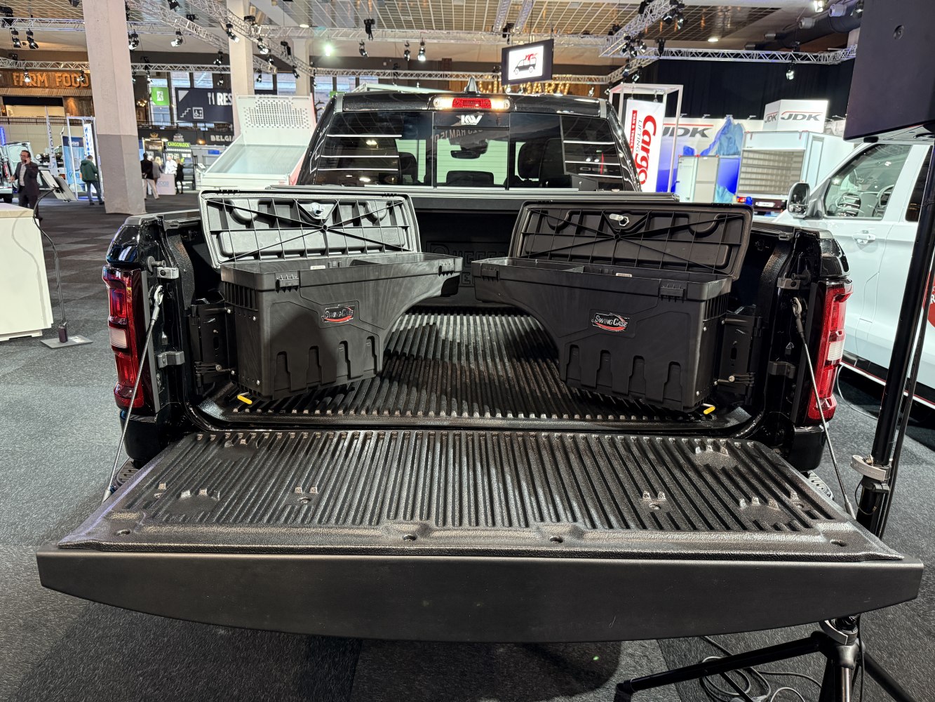 Open truck bed with two hinged black storage boxes