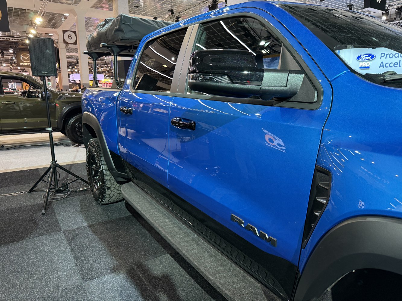 Blue truck side with black trim, doors, and mirrors
