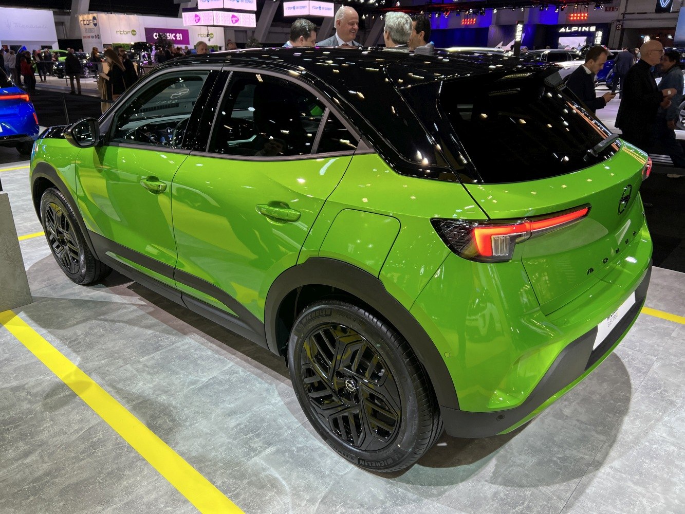 Green SUV rear quarter with black alloy wheels and modern taillights