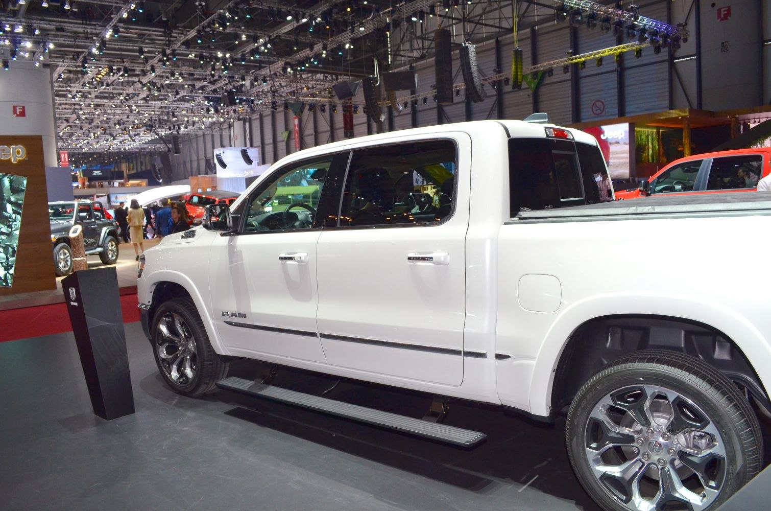 White pickup truck with chrome wheels and side step
