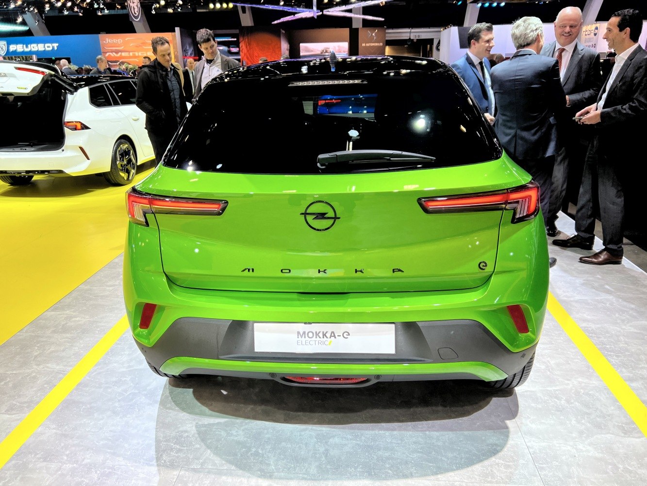 Rear view of a green electric compact SUV with LED tail lights