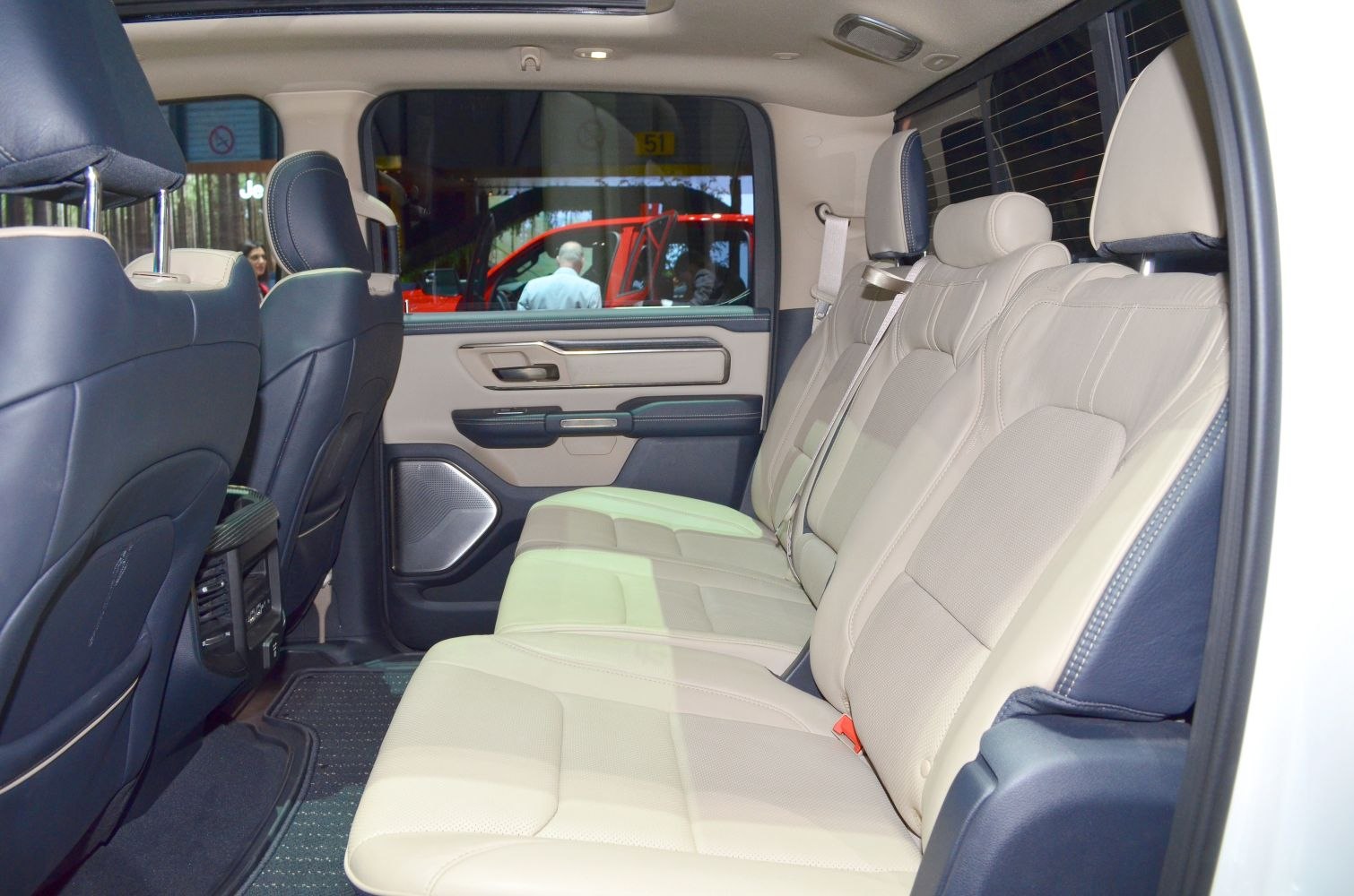 Spacious two-tone leather rear seats with detailed door panel and modern cabin features