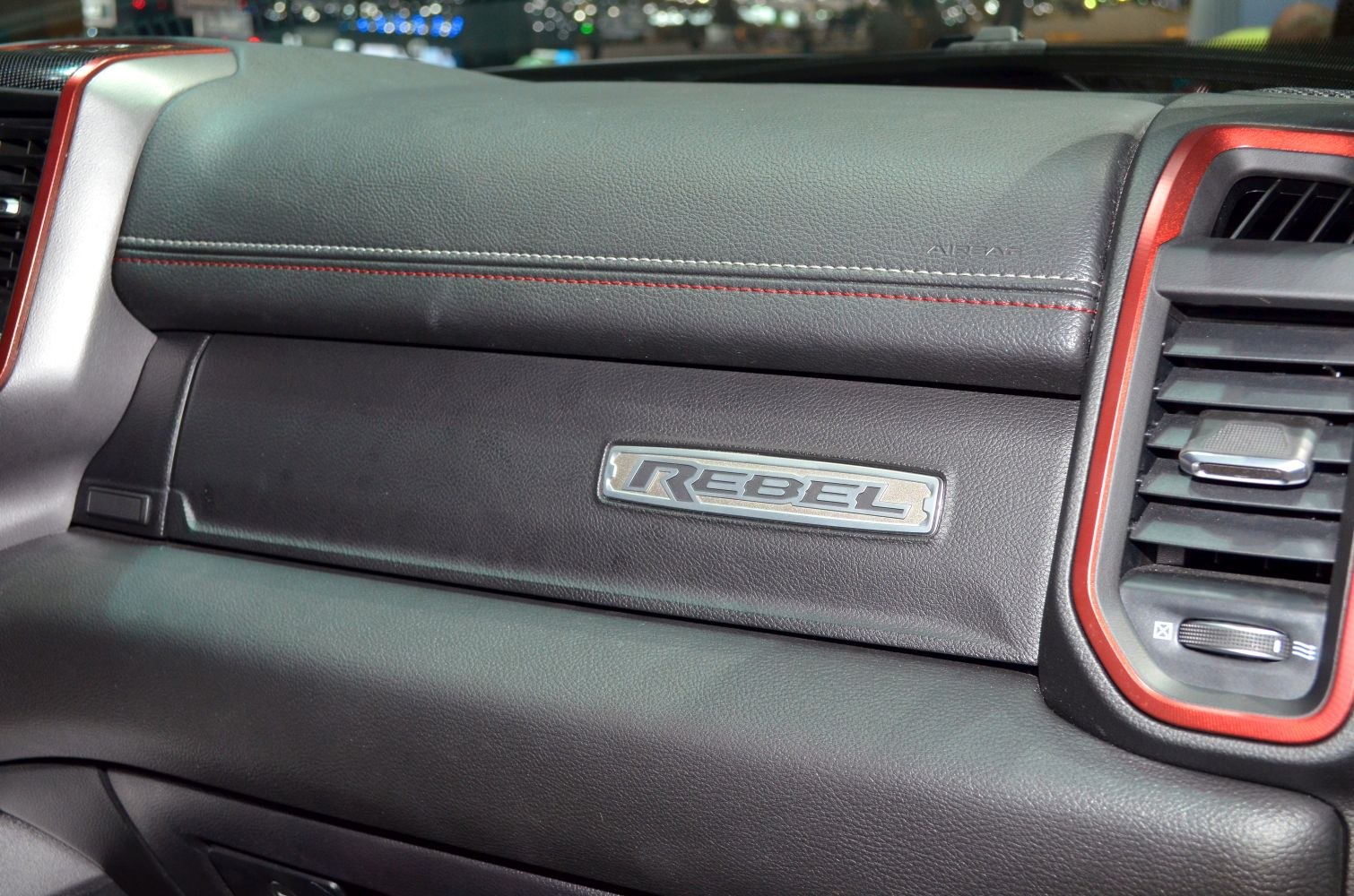 Close-up of RAM Rebel dashboard with red stitching and Rebel badge