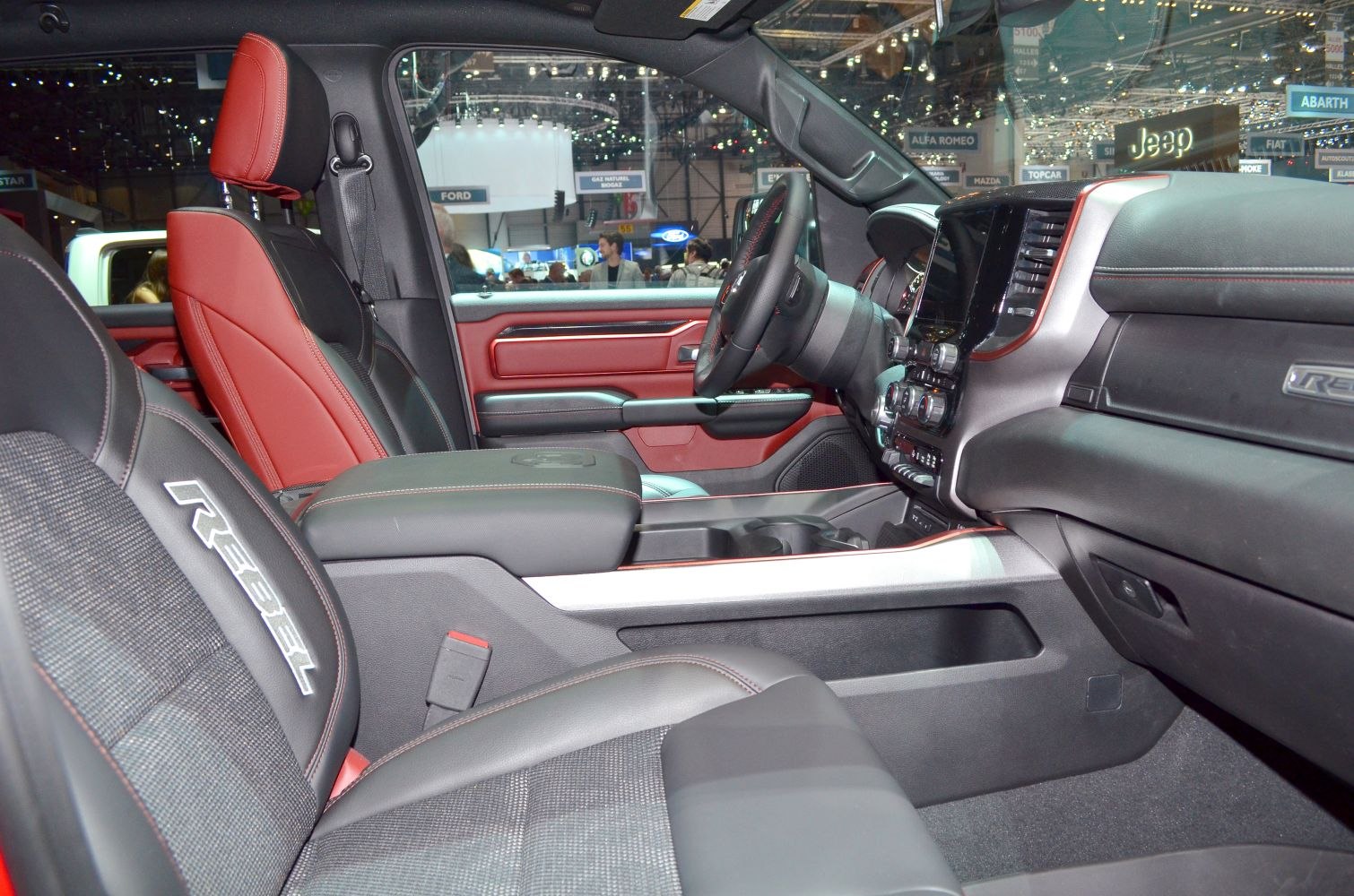 Black and red leather seats with advanced dashboard and spacious truck cabin.