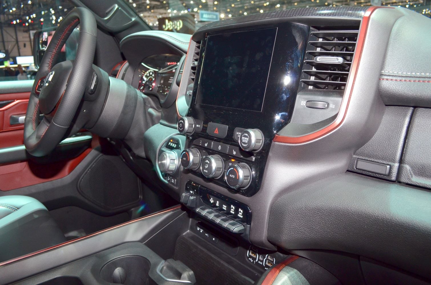 Touchscreen display and control knobs on vehicle dashboard