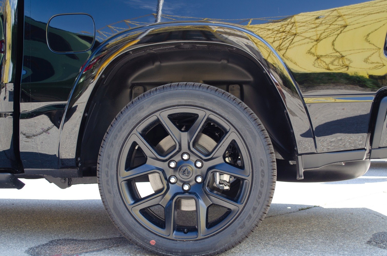 Black alloy wheel and tire on a truck.
