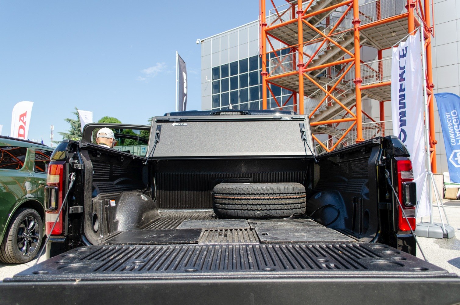 Open truck bed with spare tire and adjustable bed cover