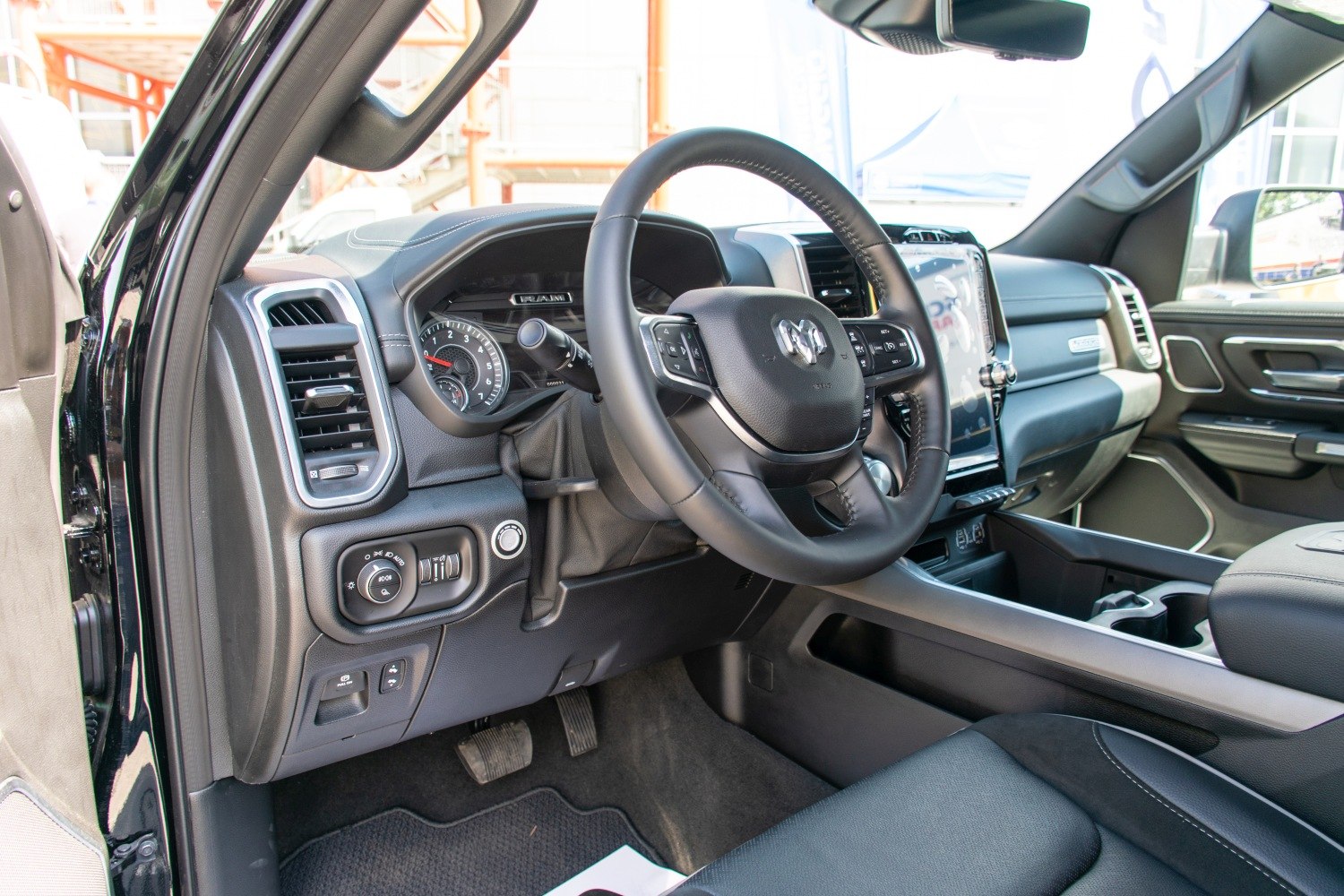 Interior dashboard and multi-function steering wheel with control buttons