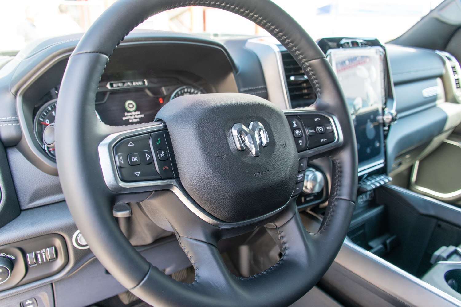 Steering wheel with control buttons and dashboard in truck interior