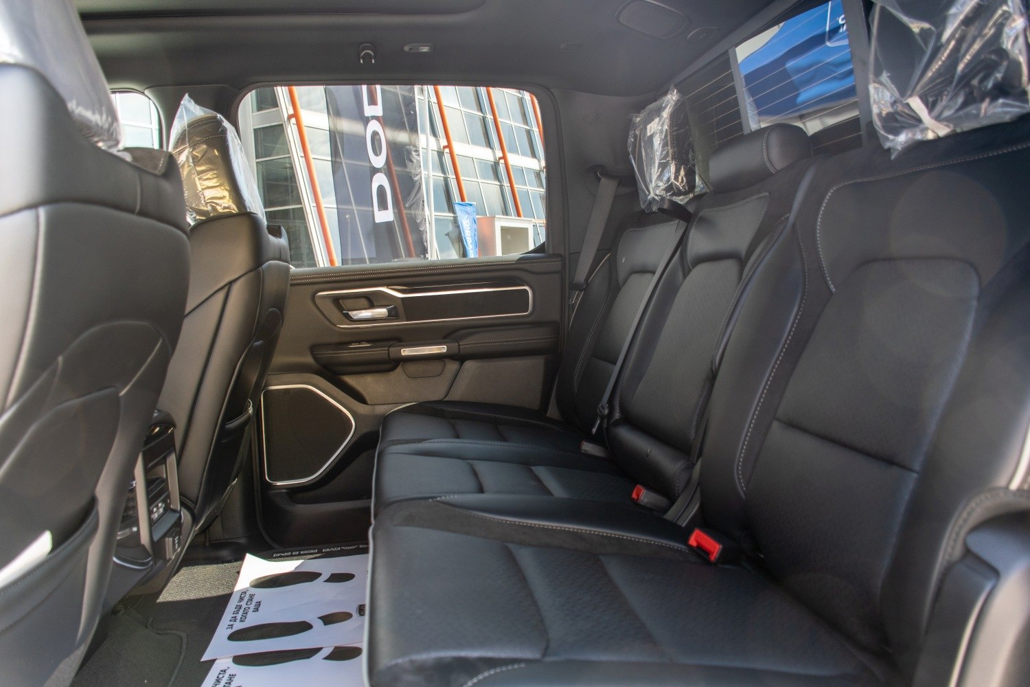 Spacious black leather rear seating and door panel with modern design