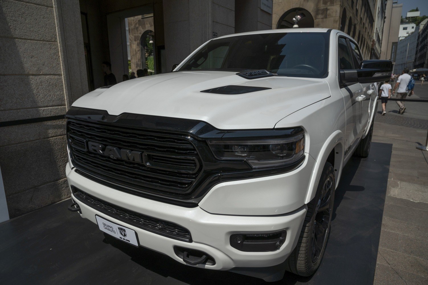 White pickup truck front with black grille and LED headlights