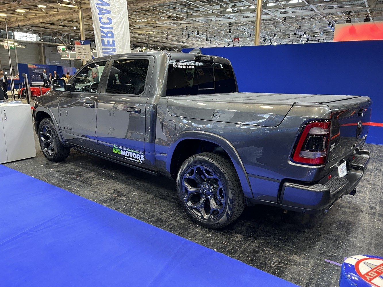 Gray pickup with tonneau cover and black alloy wheels side and rear view