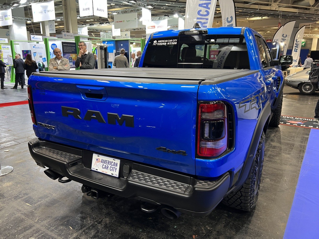Blue pickup rear view with tonneau cover and 4x4 badge