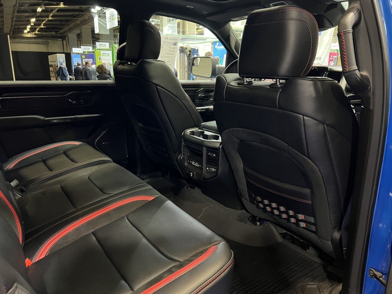 Rear black leather seats with red stitching and advanced rear console.