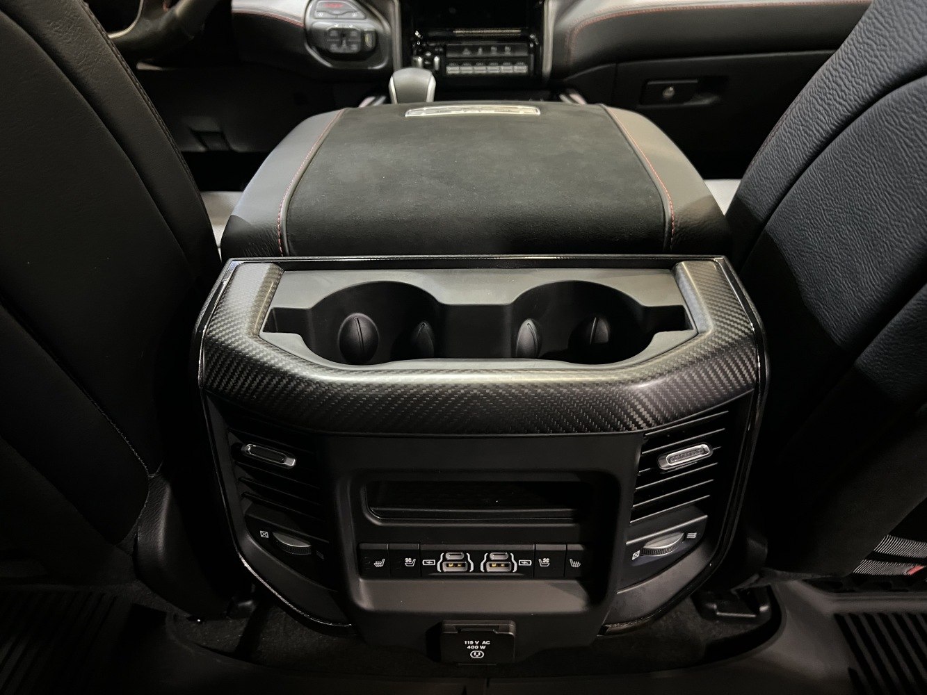 Rear console with cup holders, USB ports, and air vents