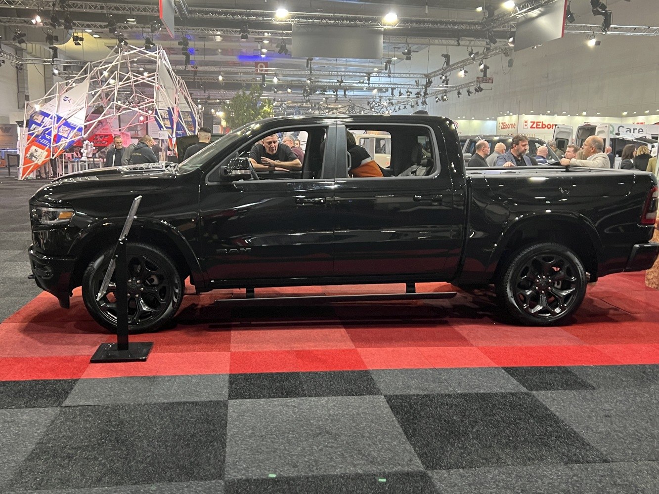 Black full-size pickup with crew cab and large black wheels