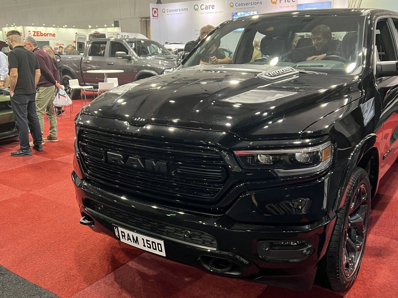 Black front grille, headlights, and hood scoop of a pickup truck