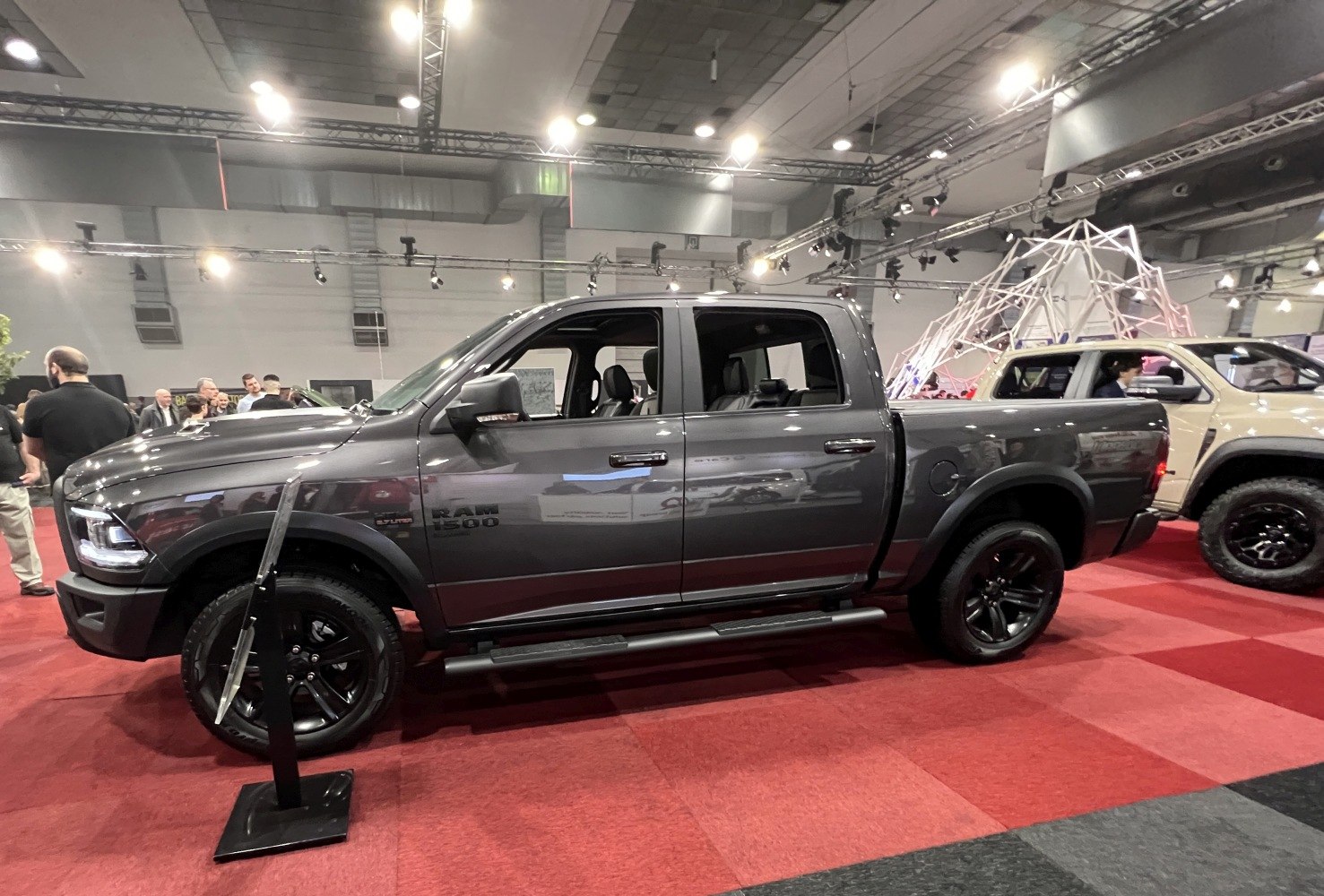 Gray crew cab pickup with black wheels and side steps