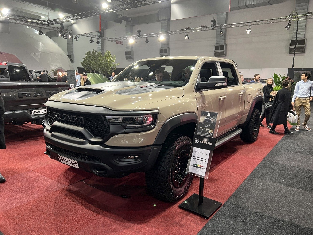 Pickup truck with aggressive front grille, hood scoop, and off-road tires