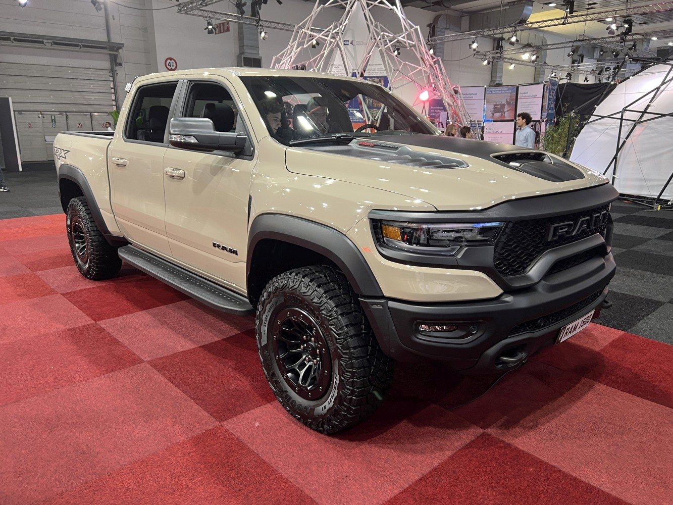 Crew cab truck with off-road tires and aggressive front hood scoop
